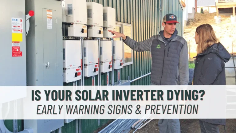 Photo of a Green Ridge Solar technician in front of a row of solar inverters, speaking with a customer about her solar panel system and solar inverters.