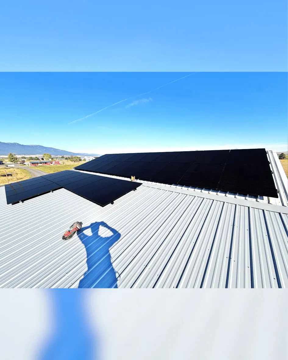 Rooftop solar panel system installed on roof of metal barn in rural Joseph, Oregon.