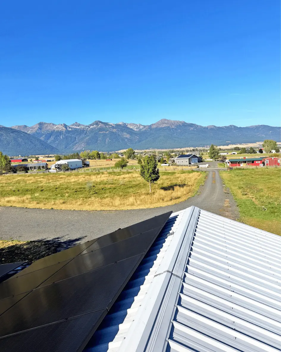 Rooftop solar panel system installed on roof of metal barn in rural Joseph, Oregon.